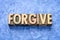 Forgive word in wood type