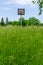 A forgotten basketball court overgrown with tall grass in the small Lithuanian town