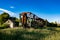 Forgotten overgrown railway. Old rusty ruined freight carriage