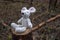 Forgotten soft toy mouse on a stump in the forest.