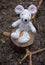 Forgotten soft toy mouse on a stump in the forest.