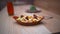 Fork on an air fried fries and sundried tomatoes dish on a wooden table