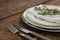 Fork and butter knife with napkin and flower arranged in a plate