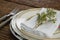 Fork and butter knife with napkin and flower arranged in a plate