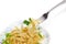 Fork with cooked spiral pasta over of dish with pasta