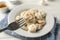 Fork with dumpling. Plate with dumplings and towel on background, close up