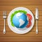 Fork with knife and globe on plate