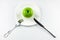 Fork, knife, green apple on white dish