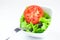 Fork,lettuce, tomato, cucumber and pepper in a bowl