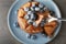 Fork with piece of tasty chocolate pancake with blueberry, closeup