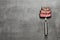 Fork with pieces of delicious barbecued meat on gray background, top view.