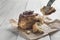 Fork pricking a piece of cinnamon roll on a rustic wooden table