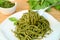 Fork Scooping Mouthwatering Whole Wheat Spaghetti with Pesto Sauce