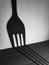 Fork shadow looking like giant fork spoon hotel dish breakfast dinner lunch