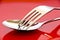 Fork and spoon over a red plate