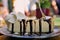 Fork Stuck into Gourmet Cheese Cake, Chocolate Sauce, Whipped Cream - Closeup