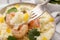 Fork with tasty couscous over plate, closeup