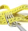 Fork wrapped in measure tape in diet and overweight concept