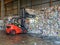 Forklift catching a recycle paper bale