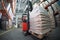 Forklift driver transporting sacks in warehouse