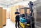 Forklift driver in a warehouse for industrial goods