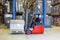 Forklift driving alongside a storage rack.