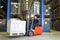 Forklift in front of storage racks