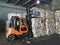 Forklift grabbing paper bales