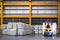 Forklift lifting cargo inside distribution warehouse. Aluminum cargo handling storage, and shipping. Logistics center.