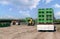 Forklift loader loads plastics containers on a truck.