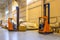 Forklift loader parking at logistics warehouse. Pallet stacker truck equipment inside of a modern warehouse storage