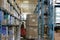 A forklift moving pallets of goods in a large warehouse