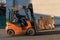The forklift operator works on the territory of the store. Transportation of goods on a forklift truck. Waste paper loading, paper