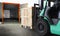 Forklift Tractor Loading Wooden Crate Boxes into Cargo Container. Shipping Trucks. Delivery Cargo Service. Supply Chain Goods