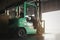 Forklift Tractor Parked in Warehouse. Forklift Loader. Shipping Warehouse Logistics