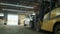 Forklift transporting a Car at a Salvage Car parts and Vehicles lot. Wide view footage