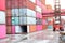 forklift truck Container boxes in a logistics yard with a stack of containers in the background