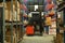 Forklift truck in large logistic distribution warehouse full of shelves with cardboard boxes