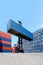 Forklift truck lifting cargo container in shipping yard