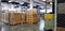 Forklift truck with a Safety Helmets Head Protectionin front of blurred large warehouse logistic or distribution center