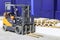 Forklift trucks for moving goods in warehouses.