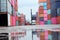Forklifts handling freight, container boxes in logistic shipping yard with stacks of cargo containers in the background