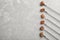 Forks with fried meat fondue pieces on grey background, top view.