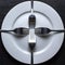 The forks are laid out in a cross on a white round plate. An empty plate with forks as a symbol of poverty and hardship