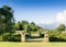 Formal garden with walls and ornamental plant pots on the edge o