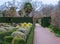 Formal Knot Garden with neat clipped cone shaped topiary bushes and hedges, photographed at RHS Wisley garden, Surrey UK.