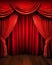 A formal red stage curtain featuring an arched entrance enhances the aesthetic appeal of the theatrical performance.