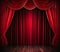 A formal red stage curtain featuring an arched entrance enhances the aesthetic appeal of the theatrical performance.