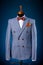 Formal suit on shop on dummy or mannequin on blue background