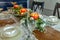 Formal table set with daisies, peach candles, and fine China plates